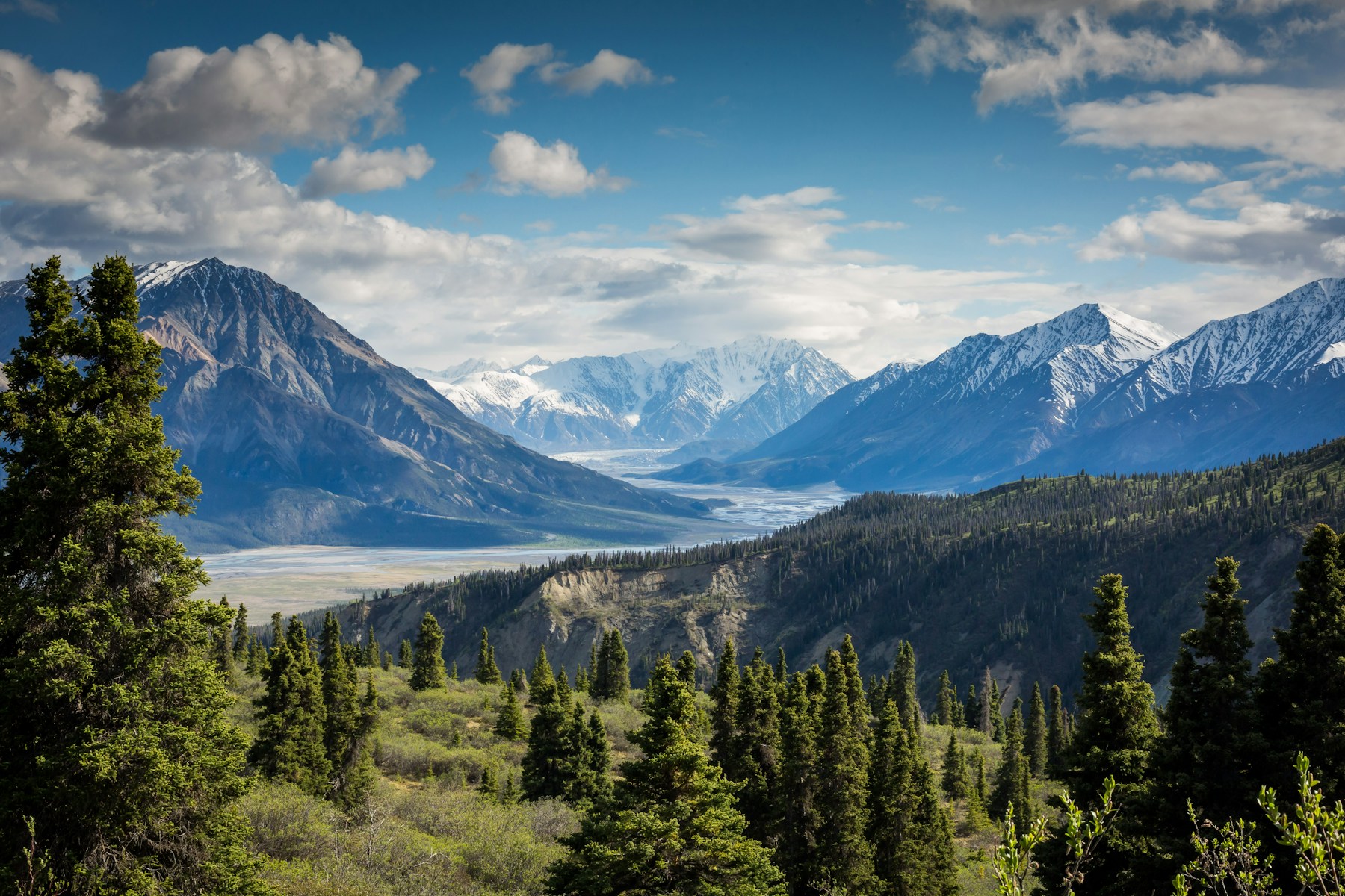 Mountain peaks and an open valley stretching toward the horizon